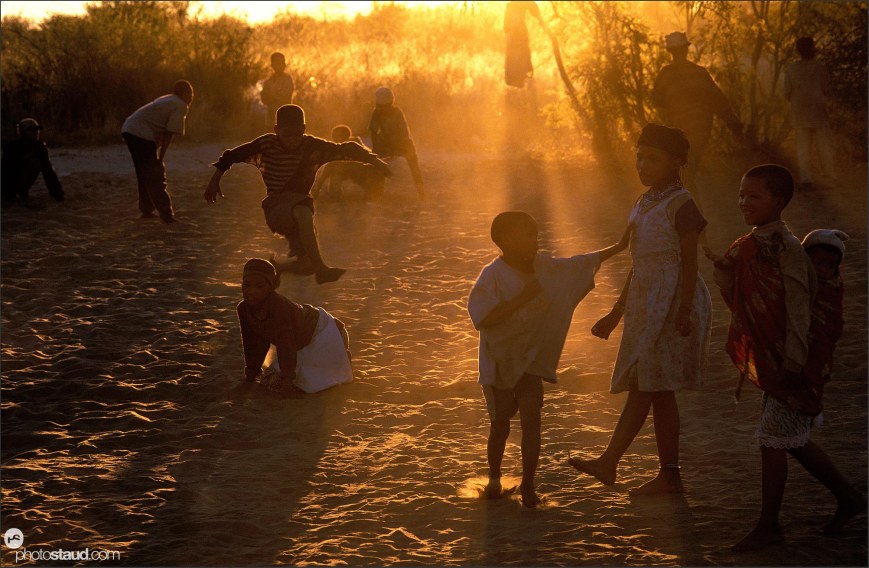 Bushman children playing in the sand, Den/ui village, Bushmanland, Namibia