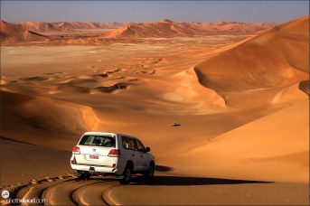 Two cars in the landscape of Empty Quarter, Rub al Khali Desert, Oman
